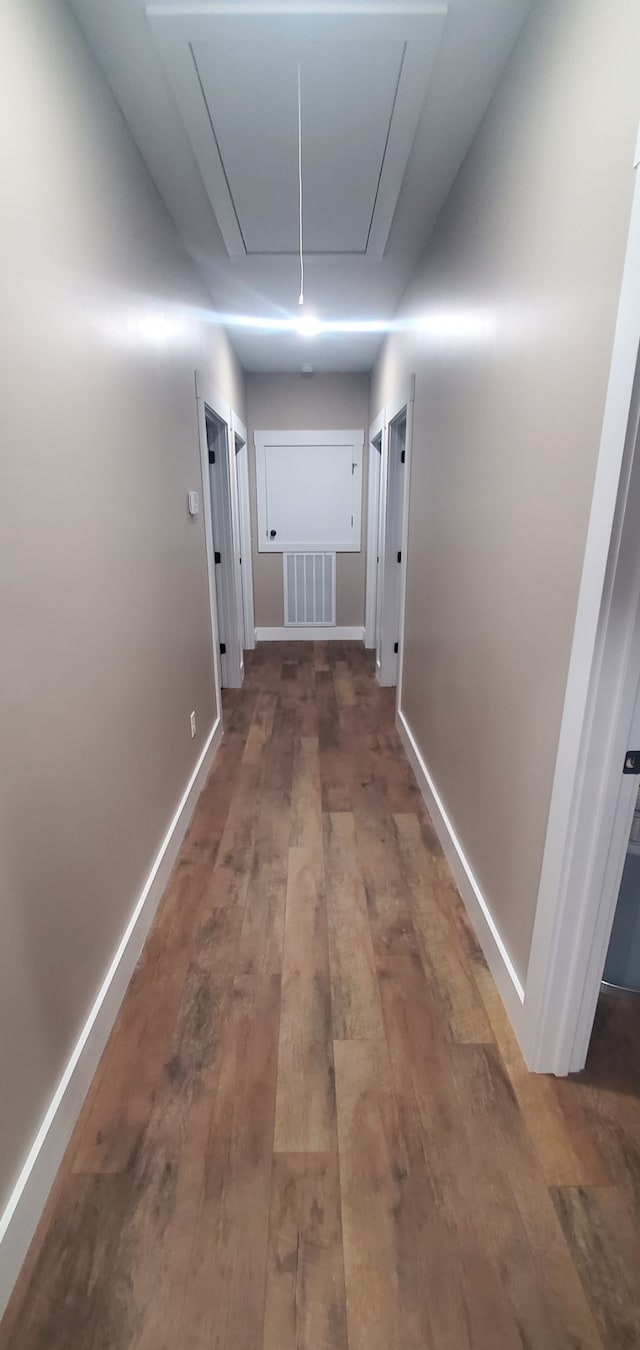 hallway with dark wood-type flooring