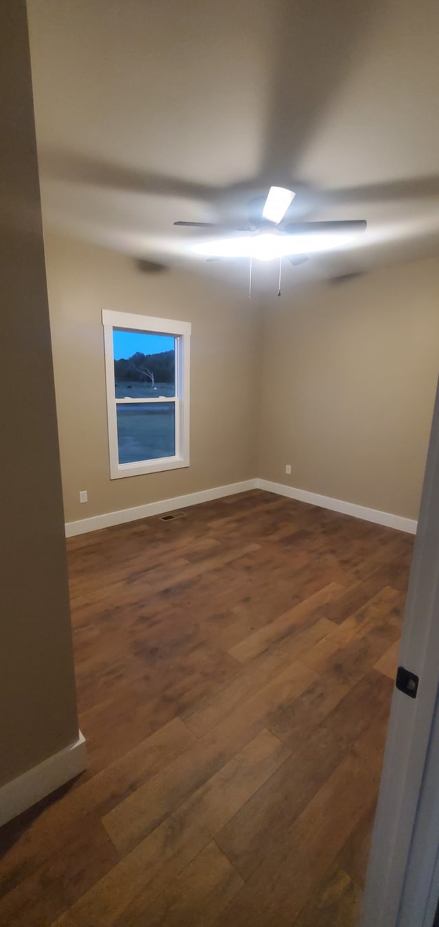 spare room featuring dark wood-type flooring