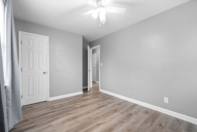 unfurnished bedroom featuring light wood-type flooring and ceiling fan