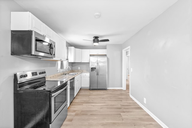 kitchen featuring light hardwood / wood-style flooring, white cabinets, and stainless steel appliances