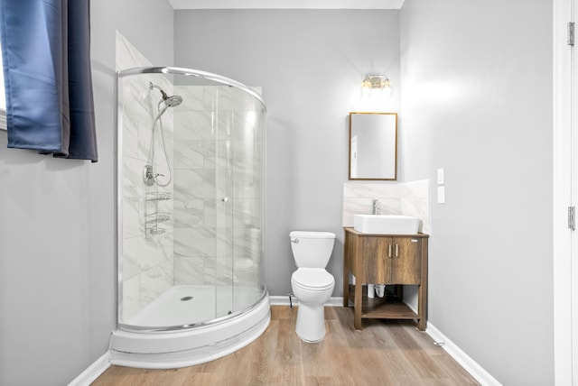 bathroom with vanity, toilet, walk in shower, and wood-type flooring