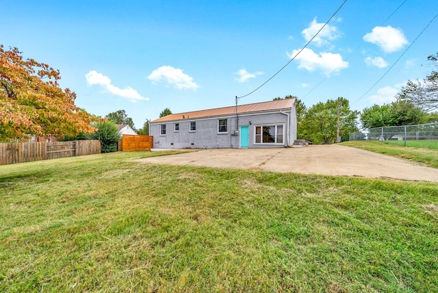 back of property featuring a patio and a lawn