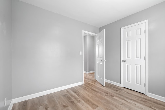 unfurnished bedroom with light wood-type flooring