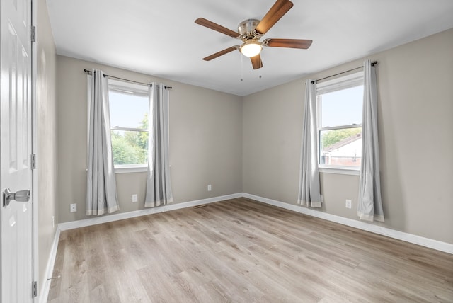 empty room with light wood-type flooring and ceiling fan