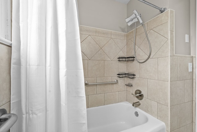 bathroom featuring shower / bath combination with curtain and tile walls