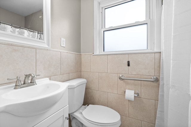 bathroom featuring toilet, a shower with curtain, vanity, and tile walls