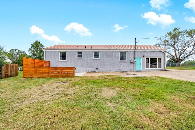 back of house with a yard and a patio