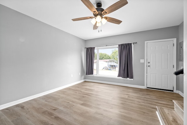 empty room with light wood-type flooring and ceiling fan