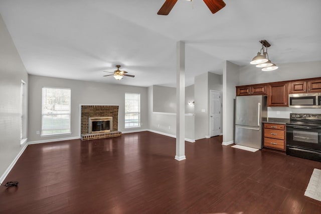 kitchen with dark hardwood / wood-style flooring, appliances with stainless steel finishes, ceiling fan, and plenty of natural light