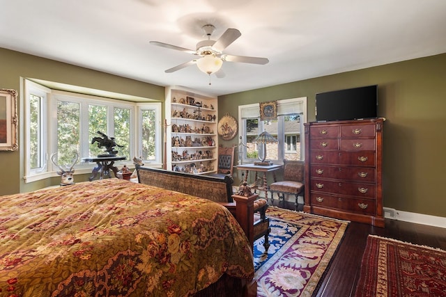 bedroom with dark wood-type flooring and ceiling fan