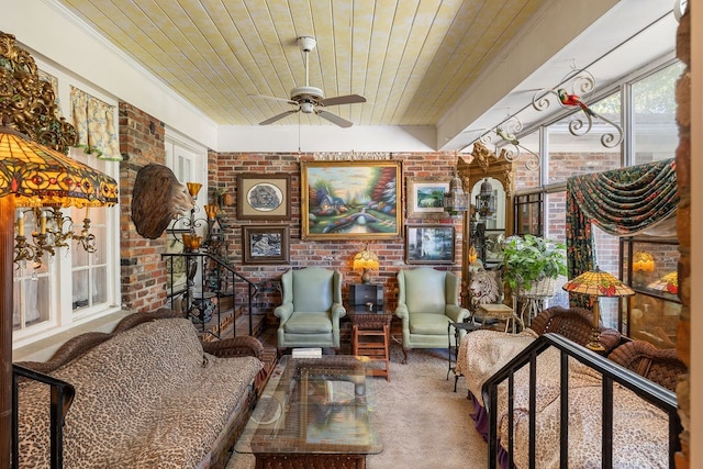 sitting room featuring brick wall, carpet, ceiling fan, and wooden ceiling