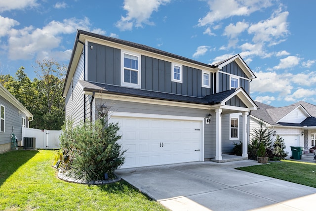 view of front of house with a front yard, a garage, and central air condition unit