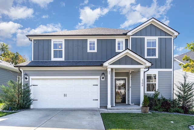 view of front of home with a front lawn and a garage