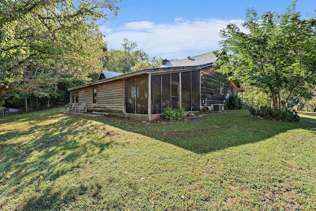 exterior space with a yard, cooling unit, and a sunroom