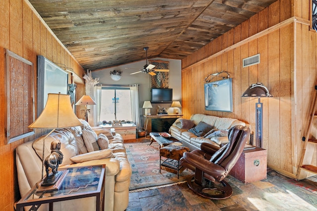 living room with wood walls and vaulted ceiling