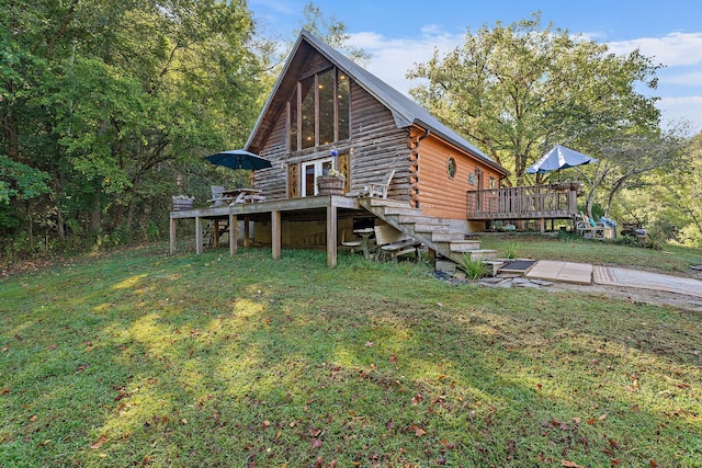 view of side of property featuring a deck and a yard