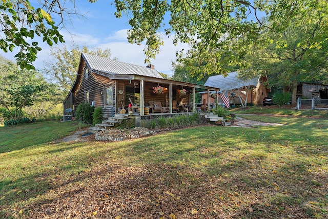 rear view of property featuring a lawn