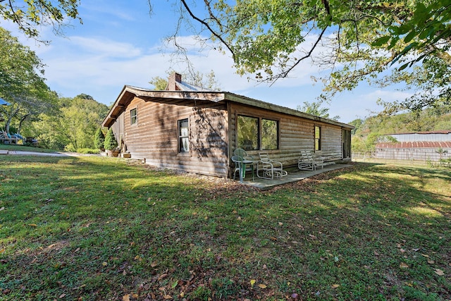 view of home's exterior featuring a yard and a patio area