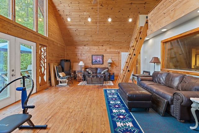 living room featuring a healthy amount of sunlight, high vaulted ceiling, and wood-type flooring