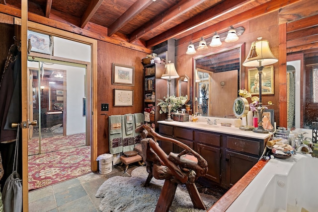 bathroom with a bathing tub, wood ceiling, beam ceiling, vanity, and wooden walls