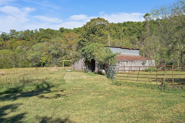 view of yard featuring a rural view and an outbuilding