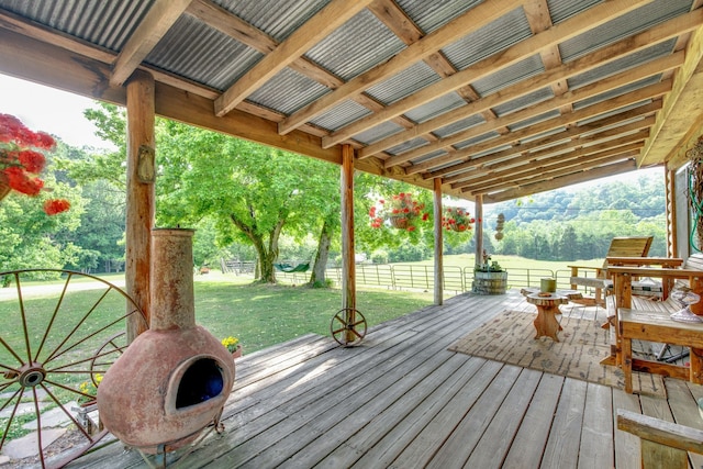 wooden terrace with a lawn