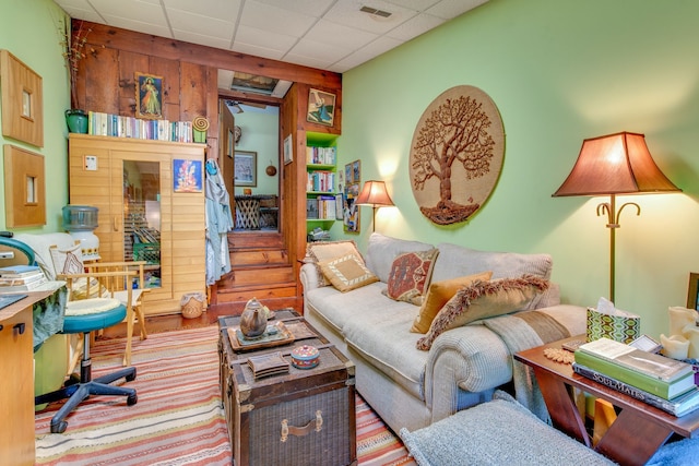 living room featuring a paneled ceiling