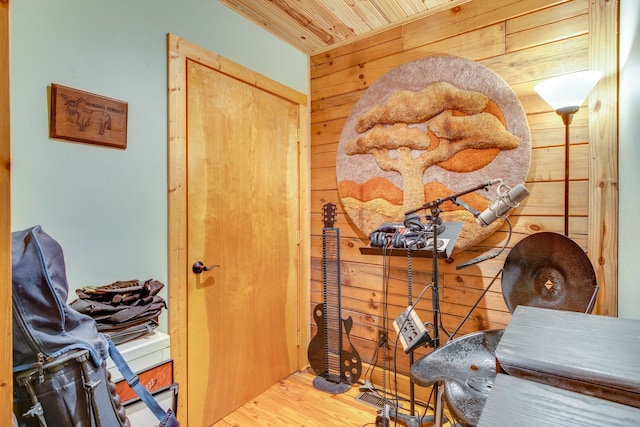 interior space with wood walls, wooden ceiling, and wood-type flooring