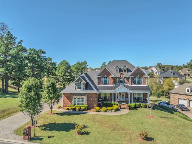 craftsman inspired home featuring covered porch and a front lawn