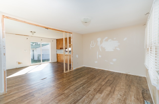 unfurnished living room with wood-type flooring