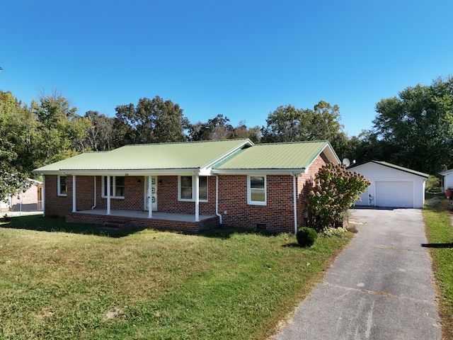 view of front facade with a porch, an outdoor structure, a front yard, and a garage