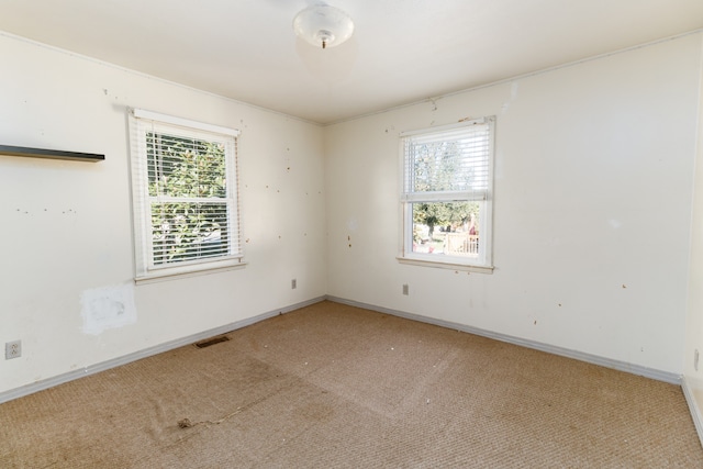 carpeted empty room with plenty of natural light