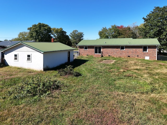 back of property featuring a yard