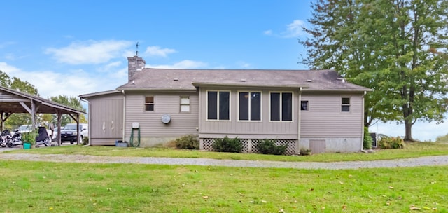 rear view of property featuring a lawn