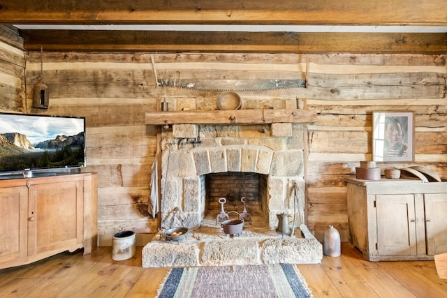 details with a stone fireplace, hardwood / wood-style floors, and beam ceiling