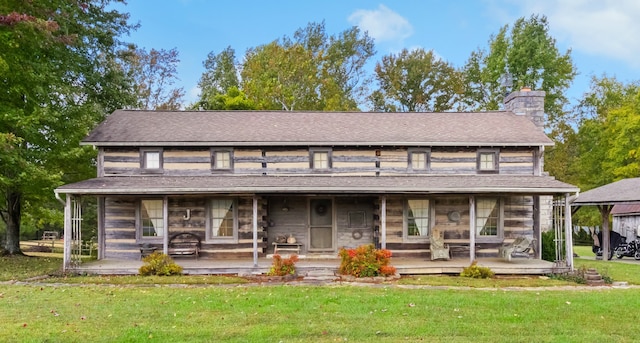 back of house with a porch and a lawn