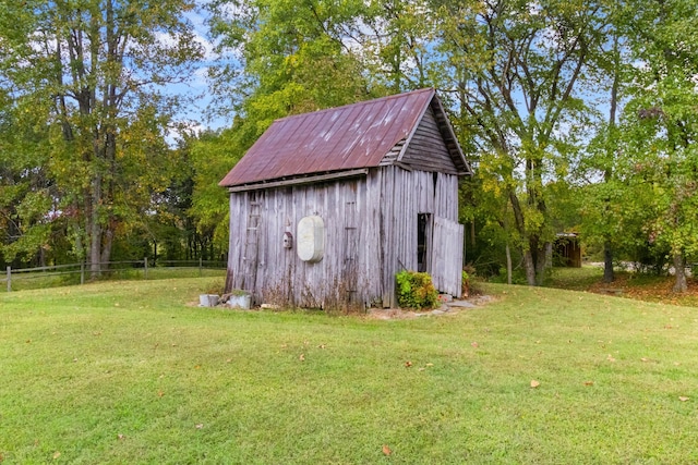 view of outbuilding featuring a yard