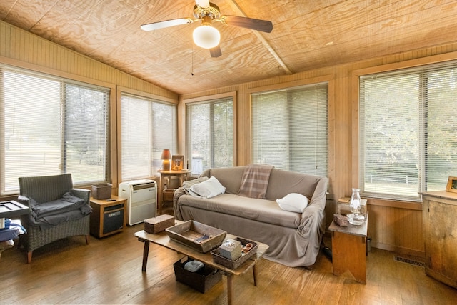 sunroom / solarium featuring wood ceiling, vaulted ceiling, a wealth of natural light, and ceiling fan