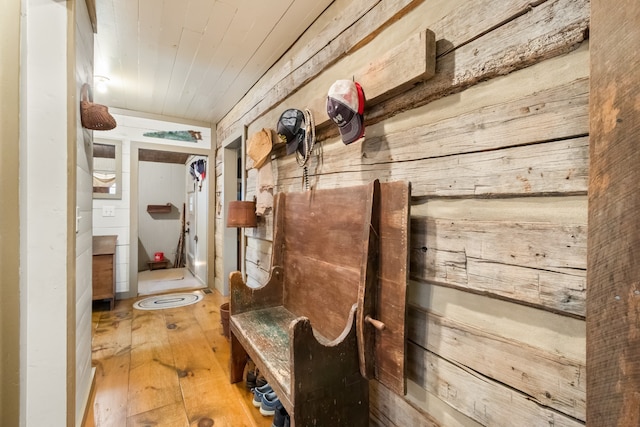 interior space with wood walls and hardwood / wood-style floors