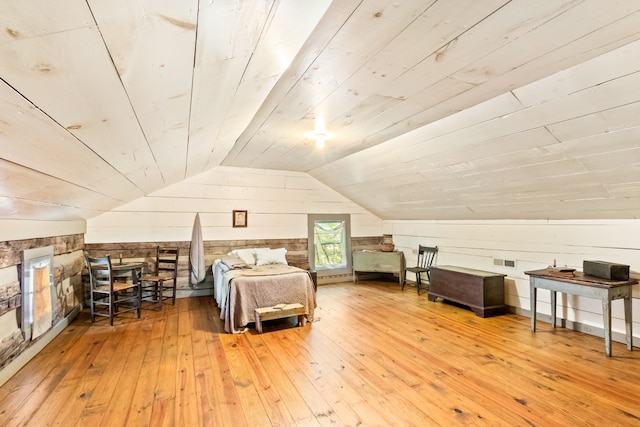 bedroom with lofted ceiling, wooden walls, wood-type flooring, and wooden ceiling