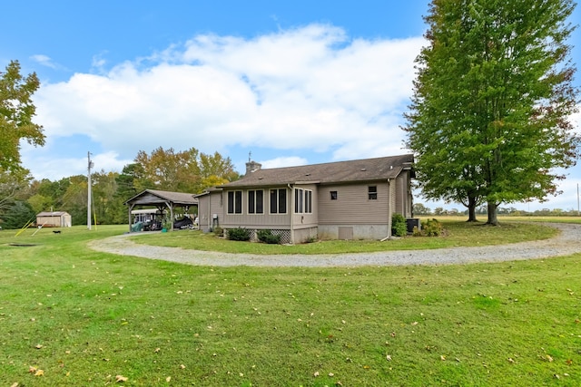 back of property featuring a gazebo and a lawn