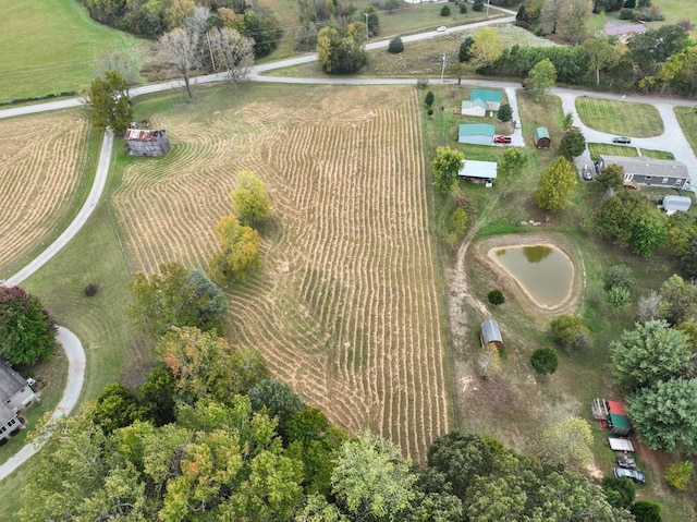 birds eye view of property with a rural view