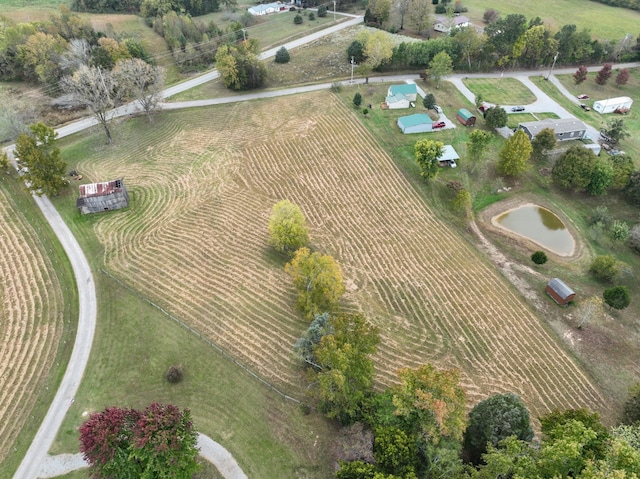 bird's eye view with a water view and a rural view