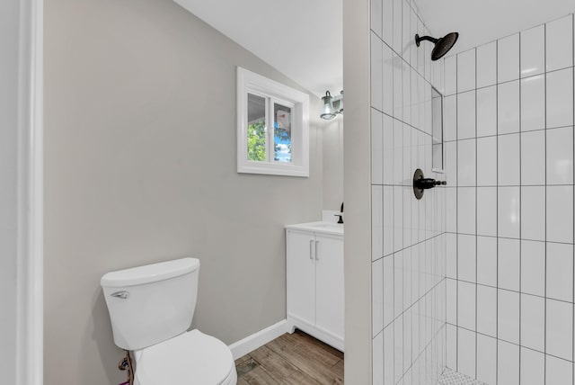 606 S Chestnut St, Monterey, TN 38574 - bathroom featuring wood finished floors, vanity, toilet, lofted ceiling, and tiled shower