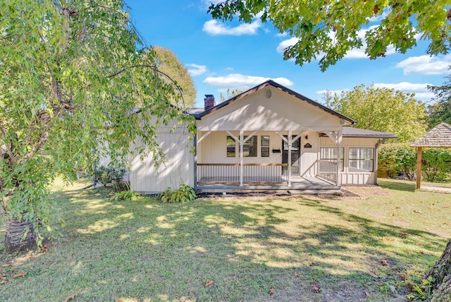 606 S Chestnut St, Monterey, TN 38574 - rear view of property with a lawn, covered porch, and a chimney