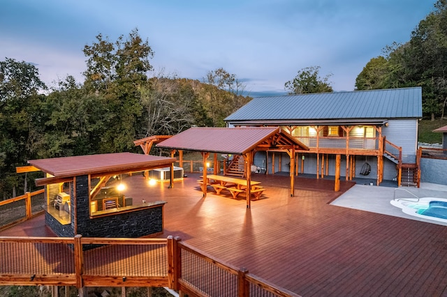 back house at dusk featuring a deck