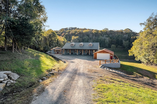 43 Landfill Ln, Brush Creek, TN 38547 - country-style home featuring an outdoor structure, a view of trees, dirt driveway, and metal roof