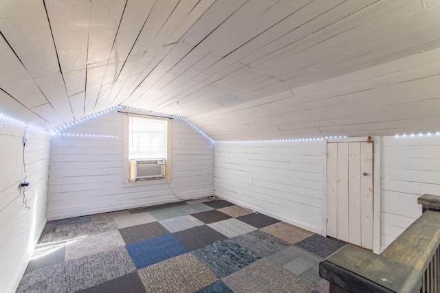 additional living space featuring lofted ceiling, wood walls, wooden ceiling, and cooling unit