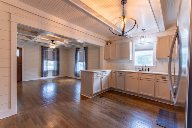 kitchen featuring sink, pendant lighting, dark hardwood / wood-style floors, and stainless steel refrigerator