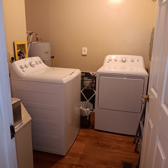 clothes washing area with water heater, independent washer and dryer, and dark hardwood / wood-style flooring